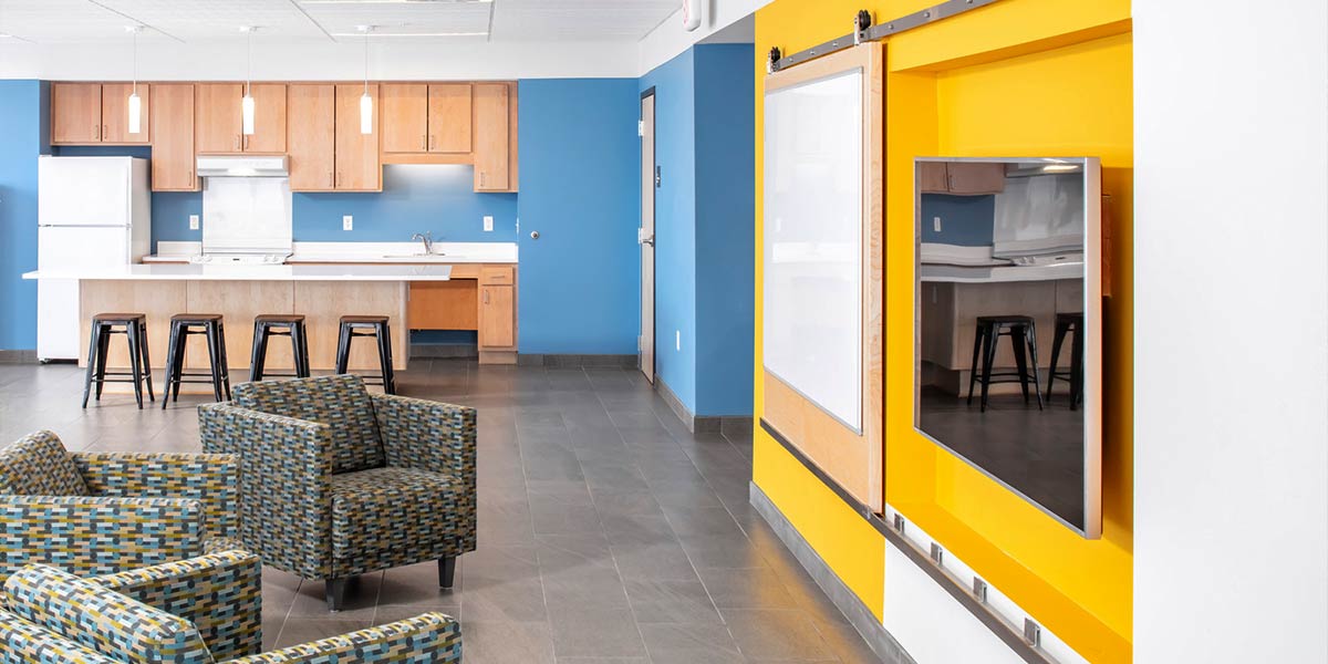 Community room with tv, chairs, and kitchenette