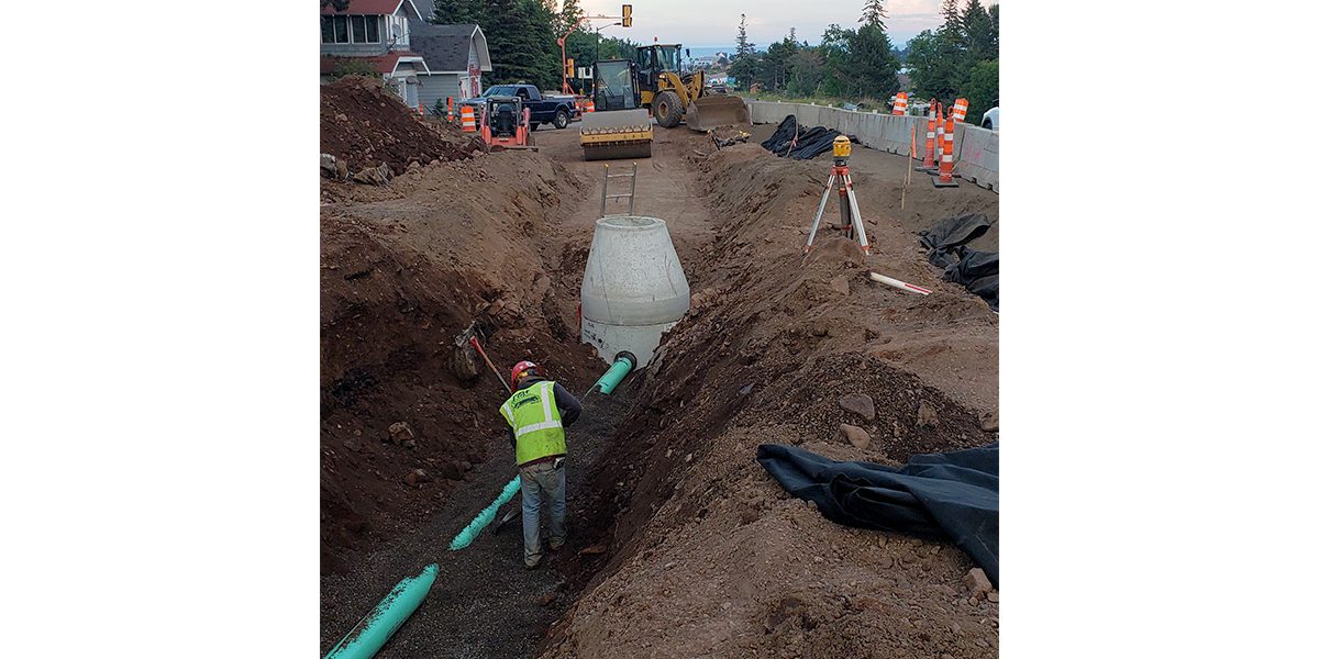 Ditch with worker and utility lines