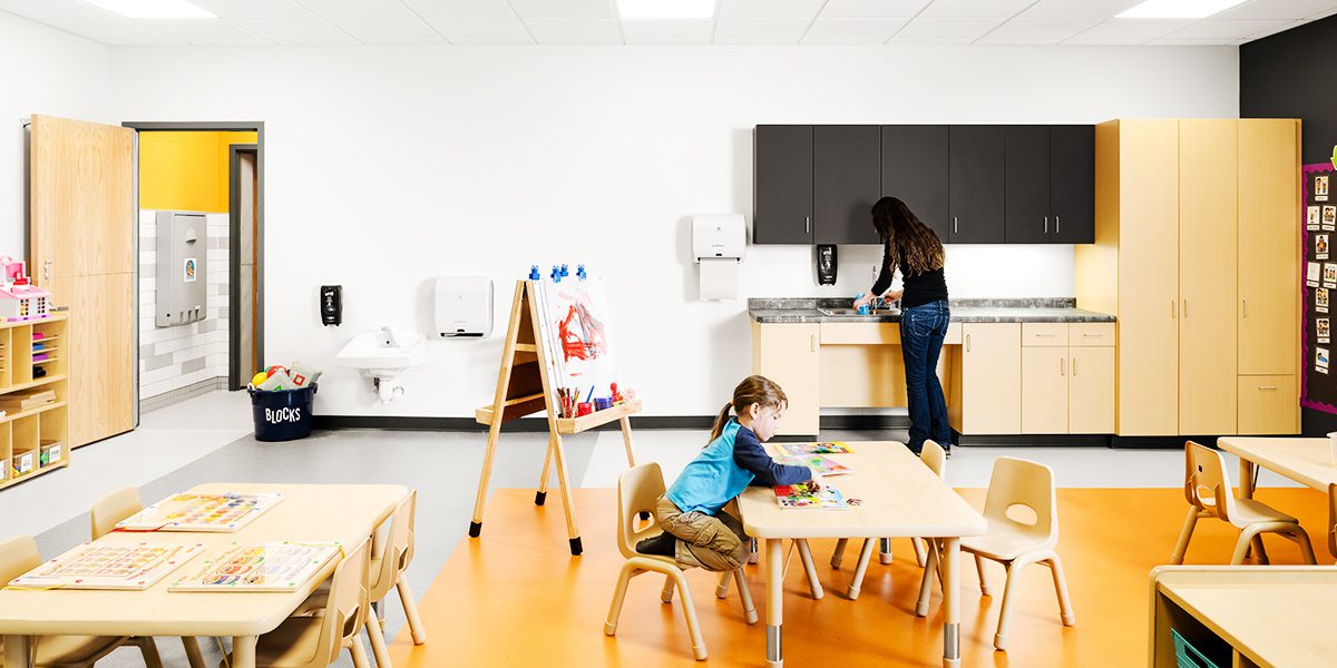 child and teacher in classroom