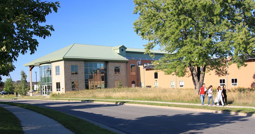 exterior of building with people walking along the sidewalk