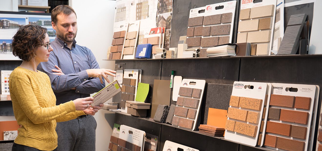 Two people looking at building material samples