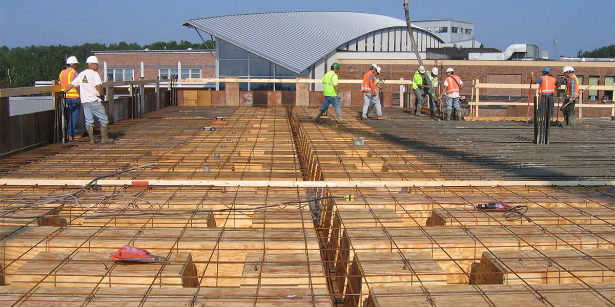 Workers pouring concrete