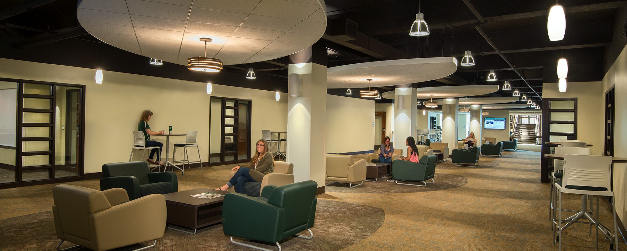 Architectural rendering of students in chairs in school lounge