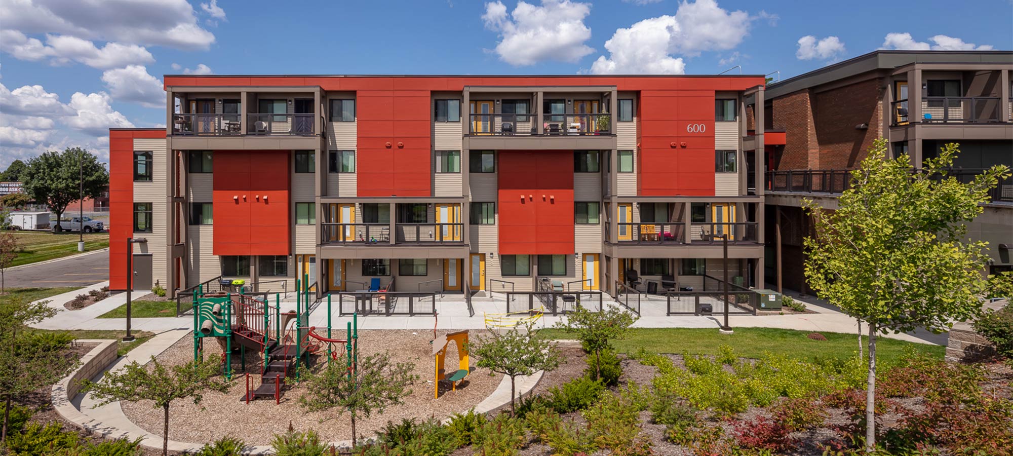 Aerial view of appartment building with playground in the front
